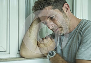 Dramatic portrait of middle aged sad and depressed man in pain feeling stressed and frustrated suffering depression problem and