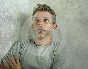 Dramatic portrait of middle aged sad and depressed man in pain feeling stressed and frustrated suffering depression problem and