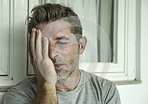 Dramatic portrait of middle aged sad and depressed man in pain feeling stressed and frustrated suffering depression problem and