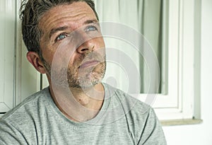 Dramatic portrait of sad and depressed 30s or 40s man in pain feeling stressed and broken suffering depression problem and anxiety