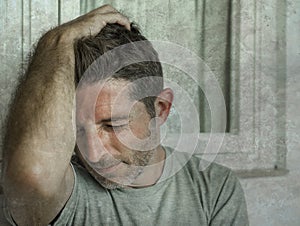 Dramatic portrait of sad and depressed 30s or 40s man in pain feeling stressed and broken suffering depression problem and anxiety