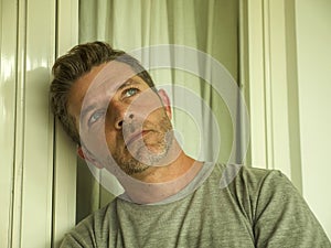 Dramatic portrait of sad and depressed 30s or 40s man in pain feeling stressed and broken suffering depression problem and anxiety