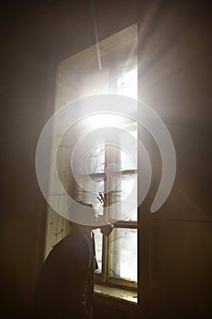 Dramatic portrait of a woman wearing a gas mask in a ruined building