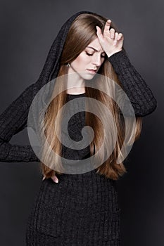 Dramatic portrait of young attractive woman with long, gorgeous dark blond hair.