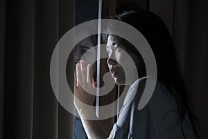 Dramatic portrait of young sad and depressed Asian Chinese woman crying desperate broken heart suffering depression and anxiety in