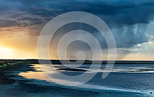 Dramatic rain storm over lake at sunset