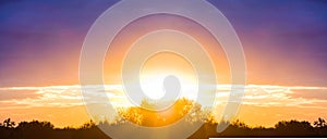 Dramatic red sunset over a forest silhouette