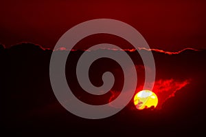 Dramatic red sunset view into rainy clouds
