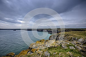 Dramatic rocky coastline of Pembrokeshire,United Kingdom on cloudy summer day.Scenic landscape without people.