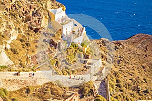 Dramatic rocky landscape Oia town steps to Santorini island coast