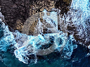 Dramatic scene of powerful waves crashing against the rocky shoreline