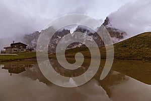 Dramatic scenery in the Dolomite Alps, Italy, in summer, with storm clouds and majestic peaks