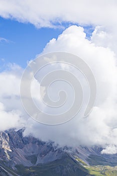 Dramatic scenery in the Dolomite Alps, Italy, in summer, with storm clouds and majestic peaks