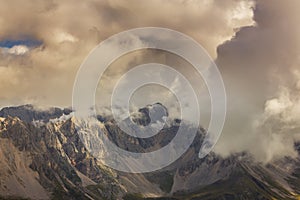 Dramatic scenery in the Dolomite Alps, Italy, in summer, with storm clouds and majestic peaks