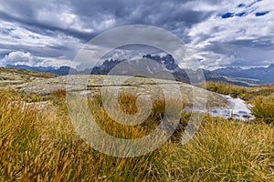 Dramatic scenery in the Dolomite Alps, Italy, in summer, with storm clouds and majestic peaks