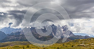 Dramatic scenery in the Dolomite Alps, Italy, in summer, with storm clouds and majestic peaks