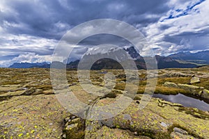 Dramatic scenery in the Dolomite Alps, Italy, in summer, with storm clouds and majestic peaks