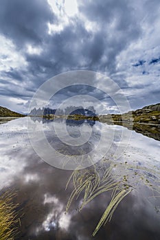 Dramatic scenery in the Dolomite Alps, Italy, in summer, with storm clouds and majestic peaks