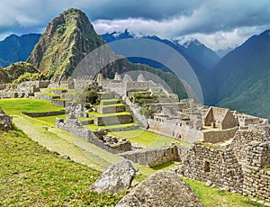 The dramatic scenery of Machu Picchu, looking at the ruins near the base of Huayna Picchu.