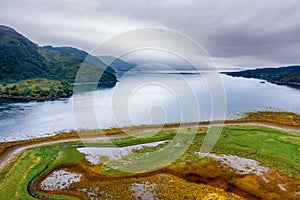 Dramatic scenery at a Scottish sea loch on a cloudy, grey afternoon Loch Duich, Eilean Donan