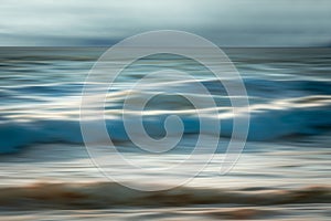 Dramatic seascape abstract. Sea waves in motion blur, and cloudy sky in the background, fine art. Pacific Ocean, California