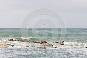 Dramatic seascape with splashing waves and rocks. Beach with rocks and beautiful waves. Rocky coastline. Seaside with cliff.