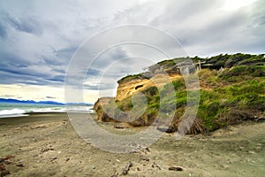 Dramatic seascape of windy wild black sand beach in Southland, Catlins, Gemstone beach, Orepuki, New Zealand, South Pacific ocean