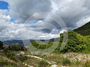 Dramatic sky behind a mountain landscape, big grey clouds