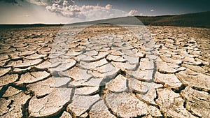 Dramatic sky with clouds over cracked earth