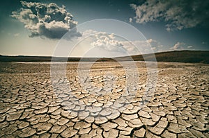 Dramatic sky with clouds over cracked earth