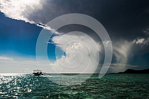 Dramatic sky with cumulonimbus clouds over turquoise South Pacific Ocean, Bora Bora photo