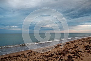 Dramatic sky with cumulus clouds over the beach