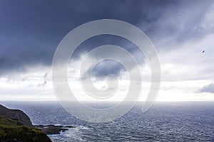 Dramatic sky over Atlantic Ocean coast near Sao Miguel Island, Azores, Portugal