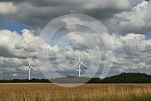 Dramatic sky over field and windmills