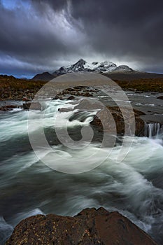 Dramatic sky over large mountains from the River Sligachan on the Isle of Skye Scotland with the Cuillin mountain range in the