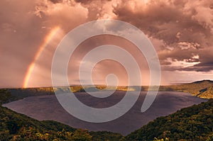 A dramatic sky and rainbow during sunset on Laguna de Apoyo from Mirador de Catarina, Nicaragua photo