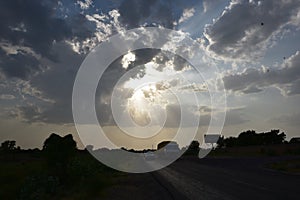 Dramatic sky with sunlight rays coming out of clouds