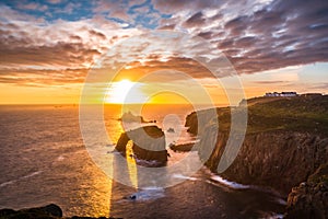 Dramatic sky at sunset with Enys Dodnan and the Armed Knight rock formations at Lands End