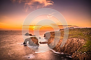 Dramatic sky at sunset with Enys Dodnan and the Armed Knight rock formations at Lands End