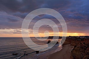 Dramatic sky at sunset over the Atlantic Ocean. Praia dos Careanos in Algarve, Portugal