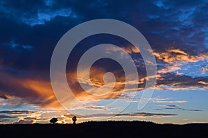 Dramatic sky whith orange clouds at sunset in the countryside in Utah USA