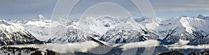 Dramatic snow covered mountains Landscape. Amazing Panoramic snowy winter landscape in Alps at sunrise morning. View