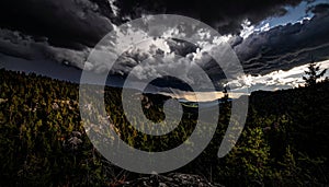 Dramatic Storm Clouds Over Forested Mountain Landscape