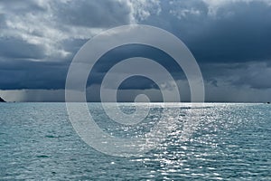 Dramatic storm clouds over tropical island