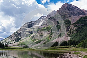 Dramatic Storm Clouds Rise Above the Maroon Bells in Central Colorado.