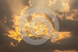 Dramatic stormy sunset with fiery glowing backlit clouds photo