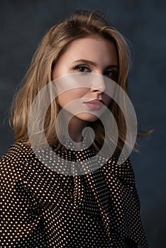 Dramatic studio portrait of a beautiful dreamy girl. Soft vintage toning.