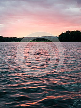 Dramatic summer sunset at the river with blue sky, red and orange clouds