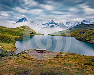 Dramatic summer view of Bachsee lake with Wetterhorn and Wellhorn peaks on background.