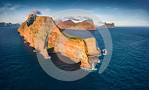 Dramatic summer view from flying droneof Kallur Lighthouse on Kalsoy island.